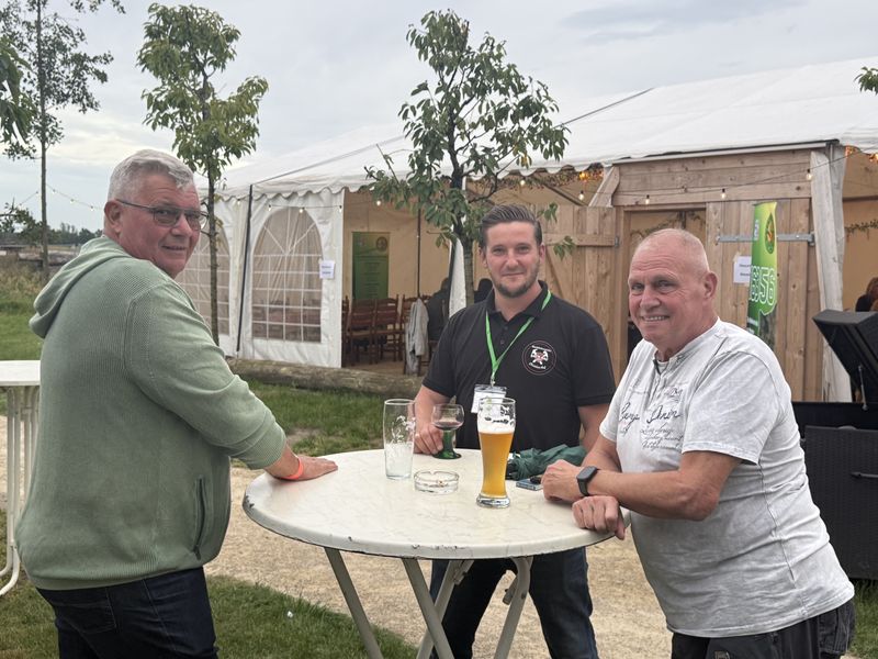 Drei Unternehmer am Stehtisch im Biergarten des Schwalbennests.